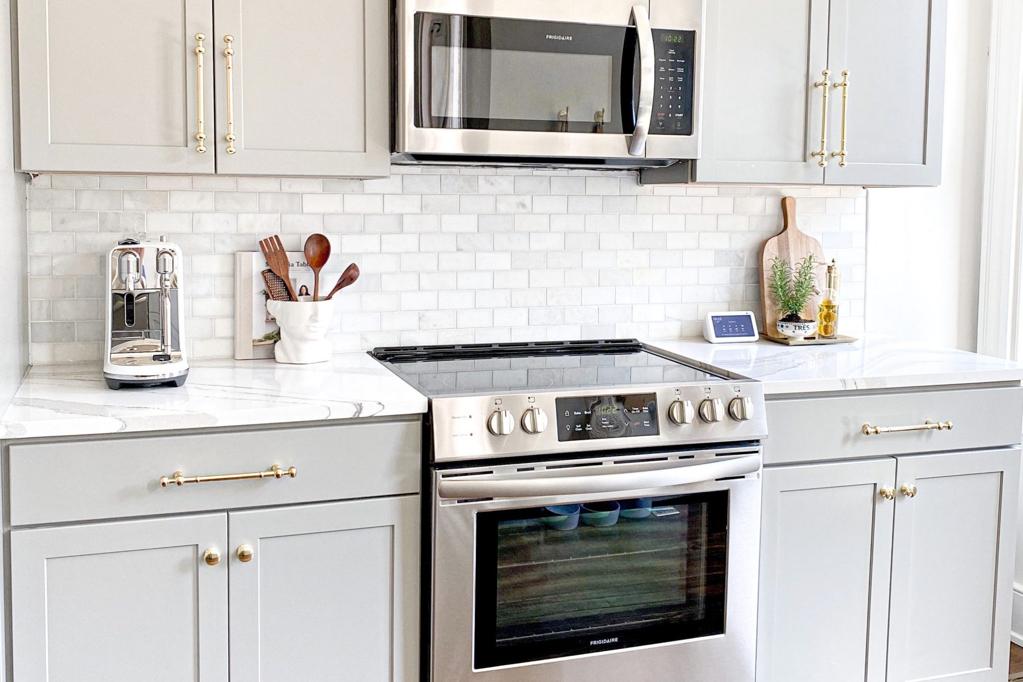 A range/stove and oven with a microwave oven range hood above it in a beautiful modern kitchen. Rexburg appliance repair